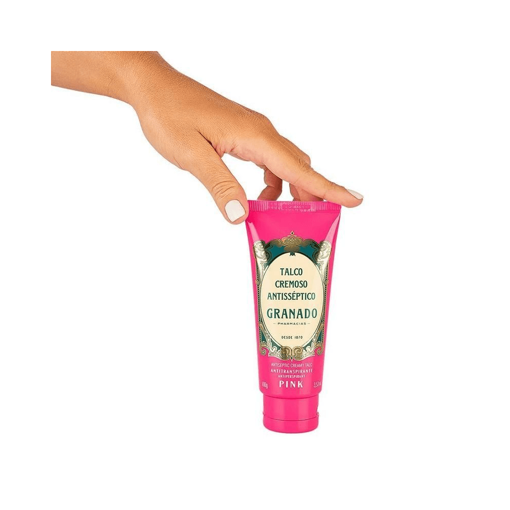 Talco Cremoso Granado Pink em uso - tubo segurado por mão feminina