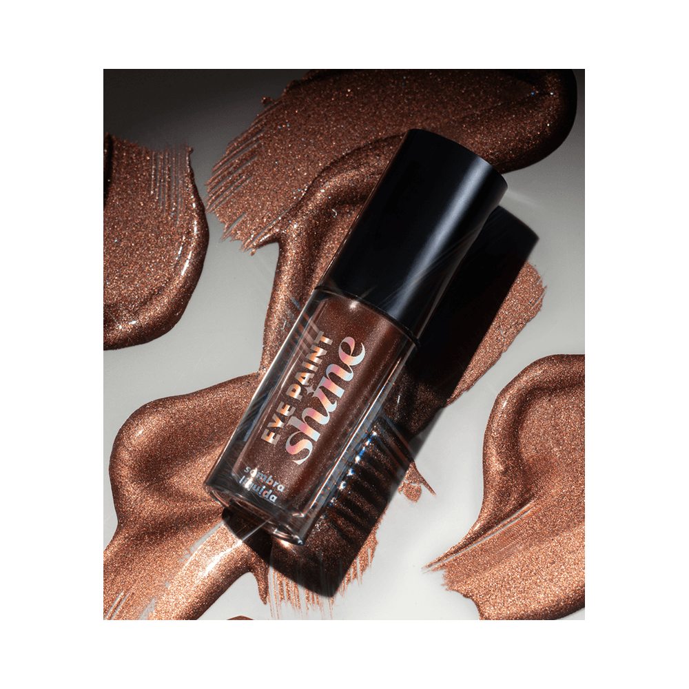 Composição artística da Sombra Dailus Eye Paint Shine Bronze destacando brilho e textura