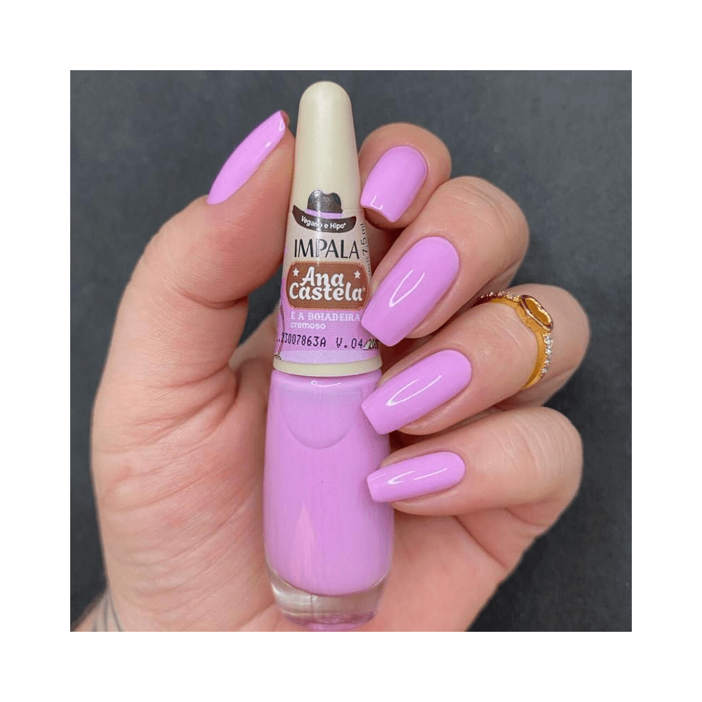 Mão segurando esmalte Impala Ana Castela, unhas feitas na mesma cor
