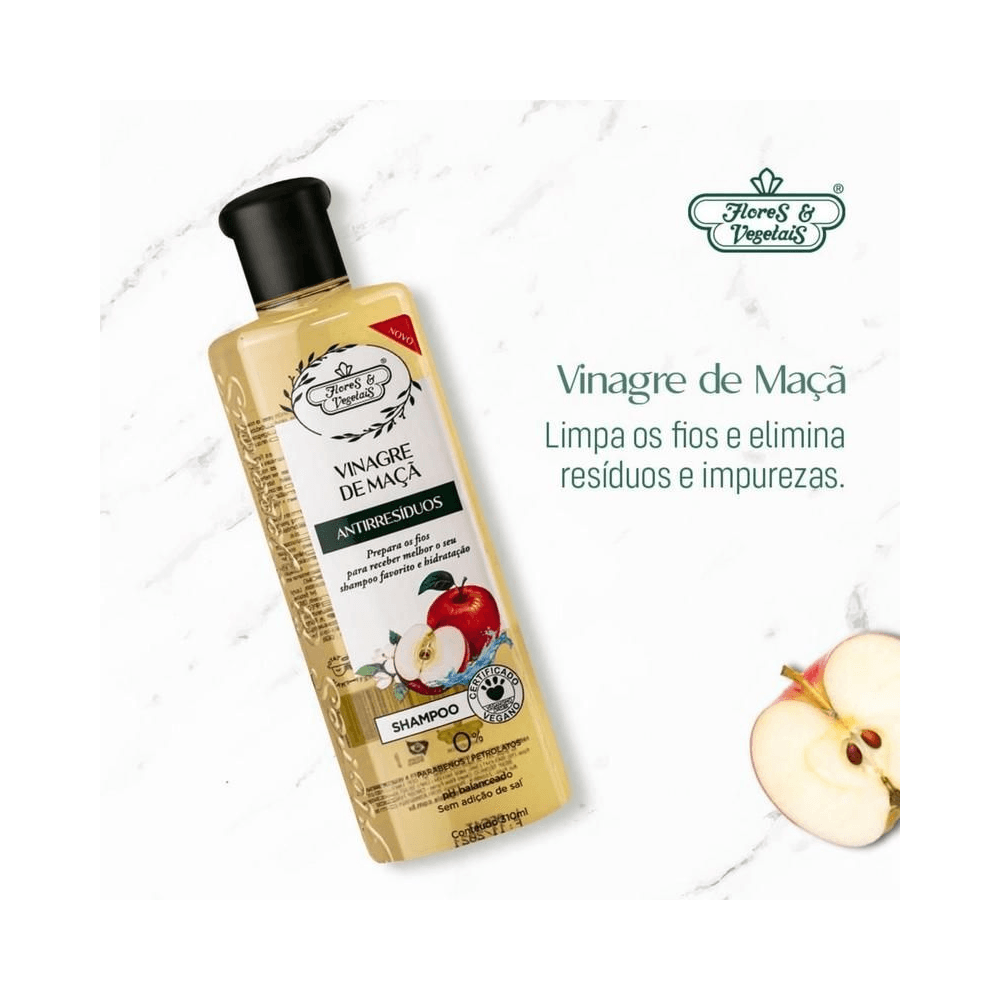 Frasco inclinado do Shampoo Vinagre de Maçã 310ml sobre fundo marmorizado