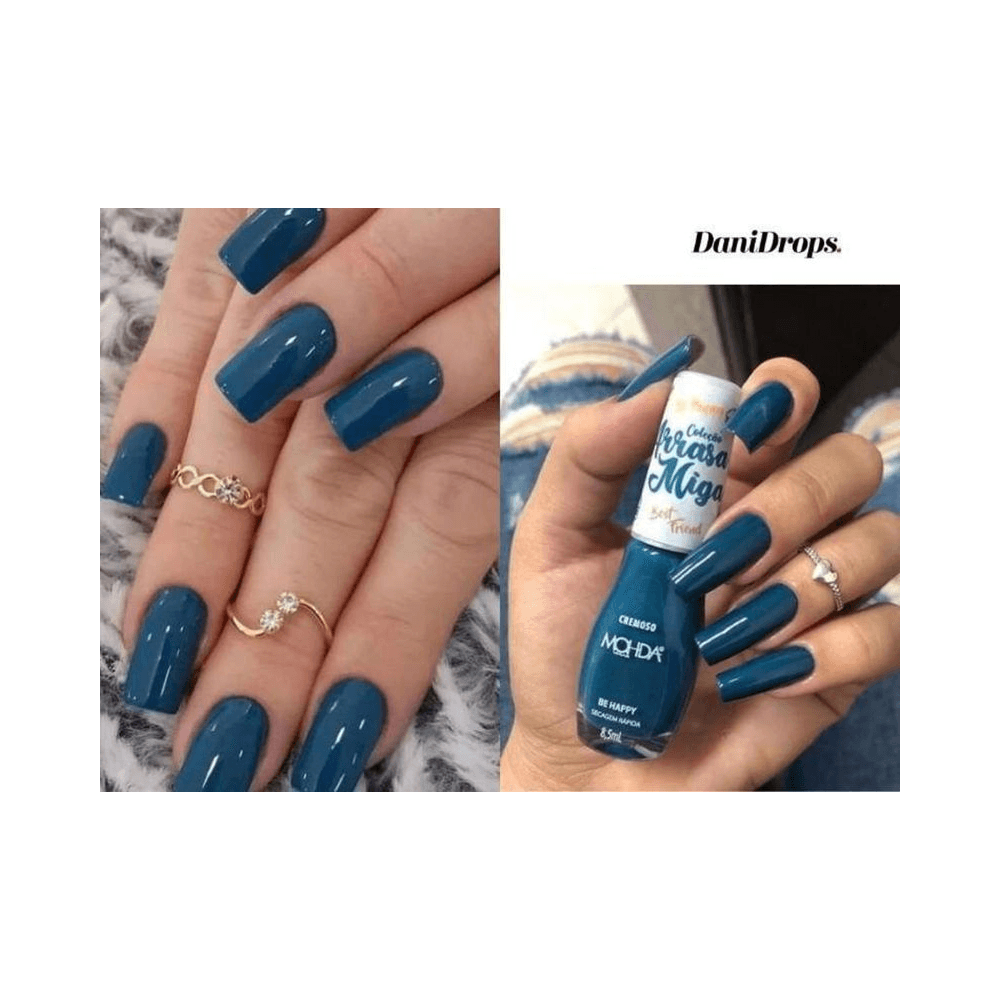 Unhas pintadas e mão segurando o frasco Mohda Arrasa Miga Be Happy mostrando cobertura